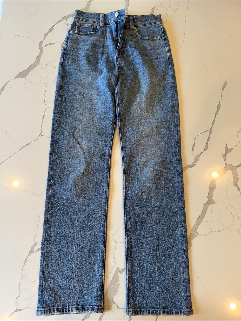 Madewell blue denim jeans with brown leather patch